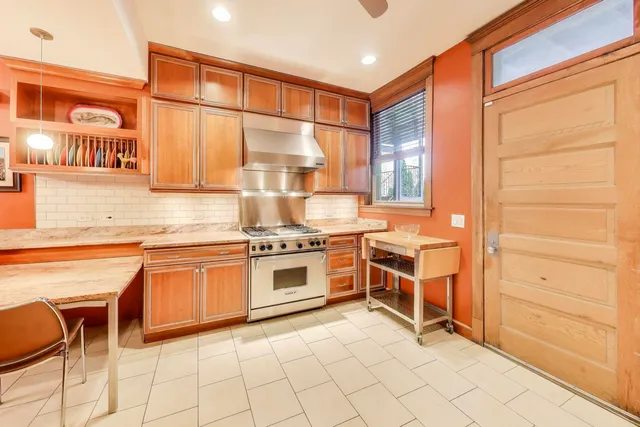 a kitchen with stainless steel appliances granite countertop a stove and cabinets