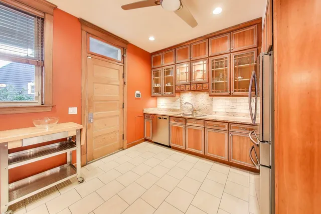 a kitchen with stainless steel appliances granite countertop a refrigerator and cabinets