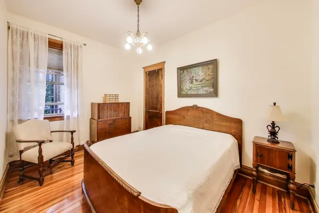 a bedroom with a bed and a chandelier