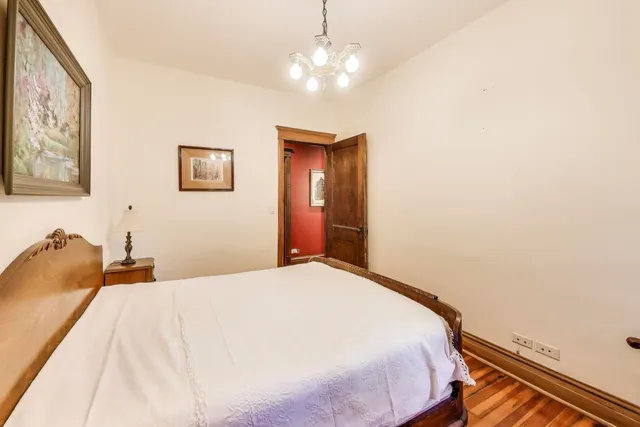 a bedroom with a bed and a chandelier