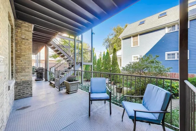 a balcony with furniture and a potted plant