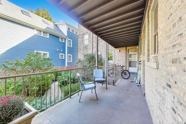 a view of a porch with chairs and backyard