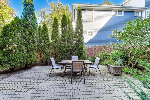 a view of a patio with a table and chairs and potted plants