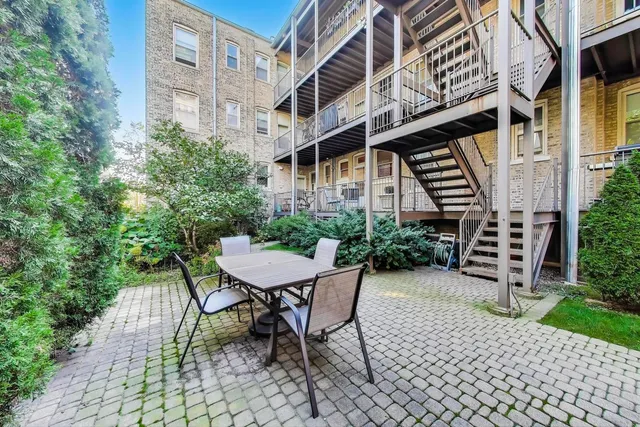 a backyard of a house with table and chairs