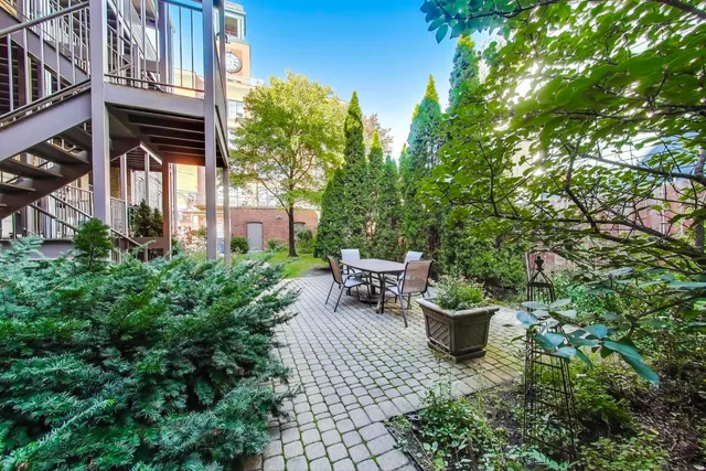 a view of a patio with chair and potted plants