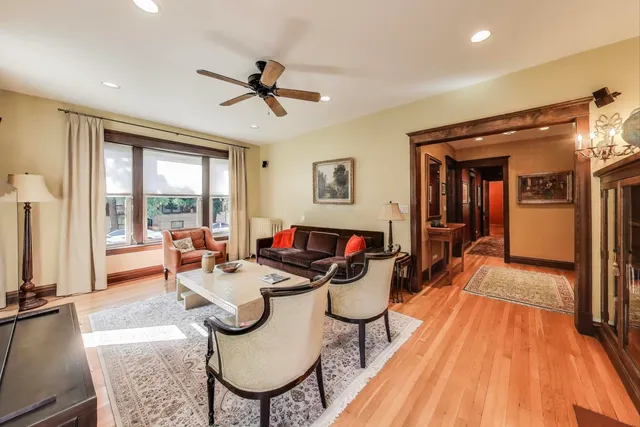 a living room with furniture a flat screen tv and a large window