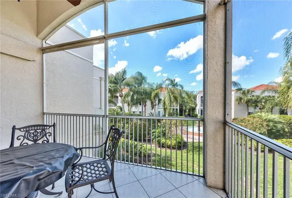 a view of a chair and table in the balcony