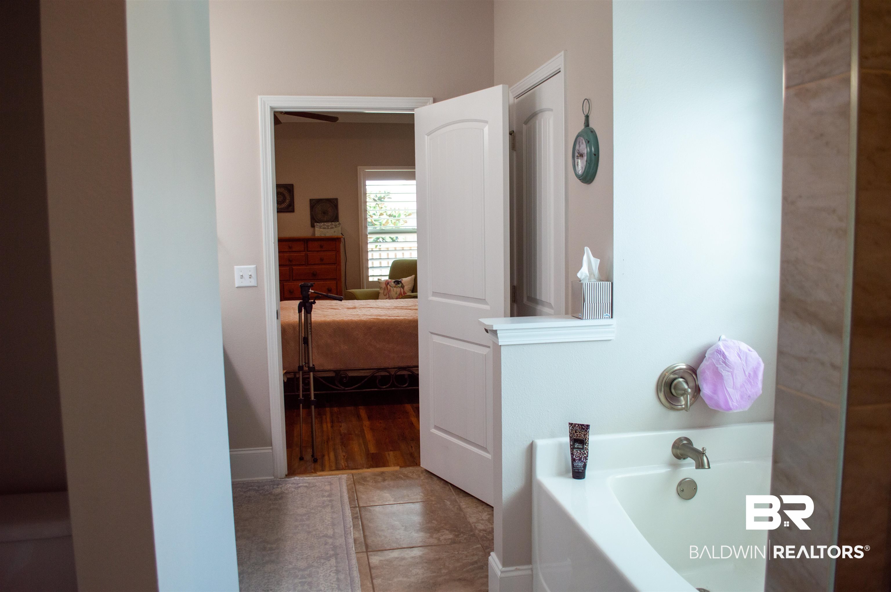 1124 West Orlando Drive Foley, AL 36535 - Photo 25 of 51 Bathroom featuring a bath, connected bathroom, and light tile patterned floors