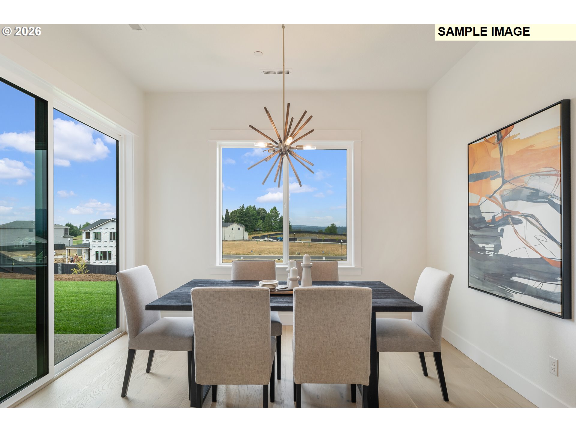 3800 South 16th Way, Unit L5 Ridgefield, WA 98642 - Photo 13 of 48 a dining room with furniture wooden floor and a floor to ceiling window