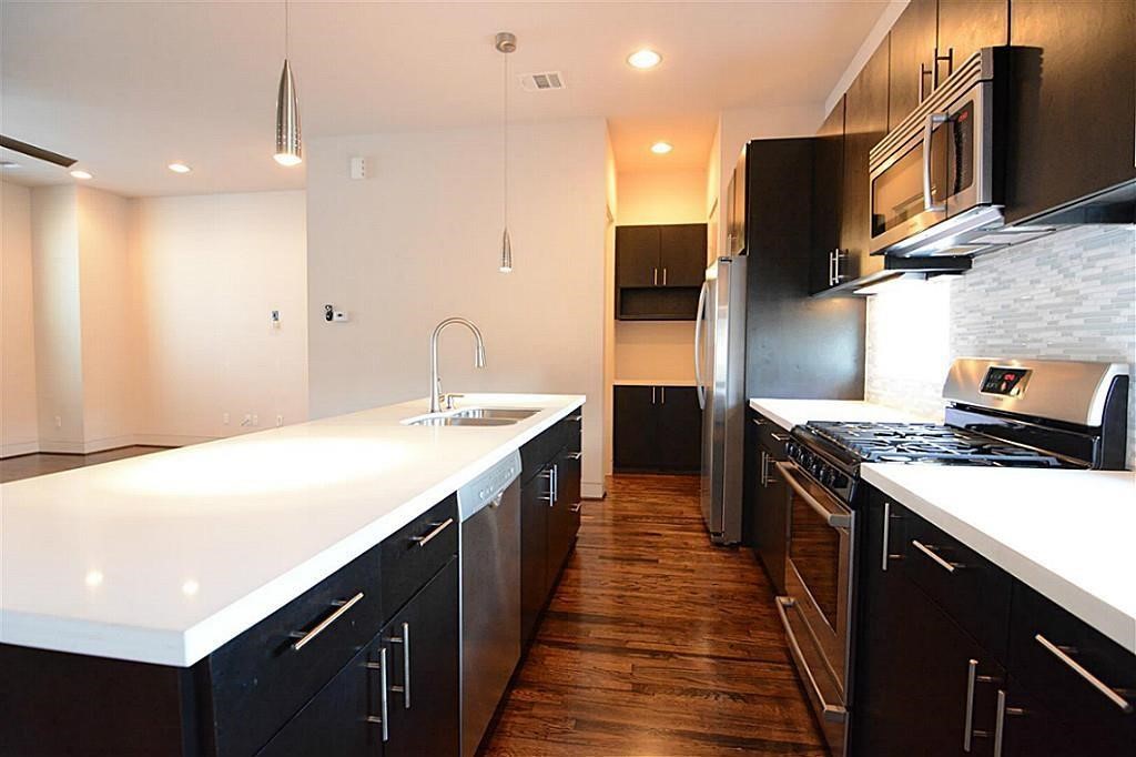 4708 Crawford Street Houston, TX 77004 - Photo 7 of 21 Modern inviting kitchen with bar and pantry
