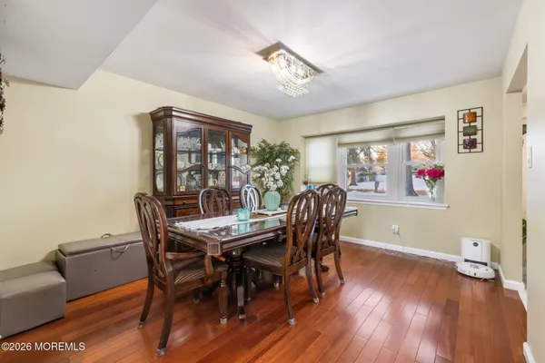 a view of a dining room with furniture wooden floor and chandelier