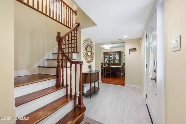a view of entryway and hall with wooden floor