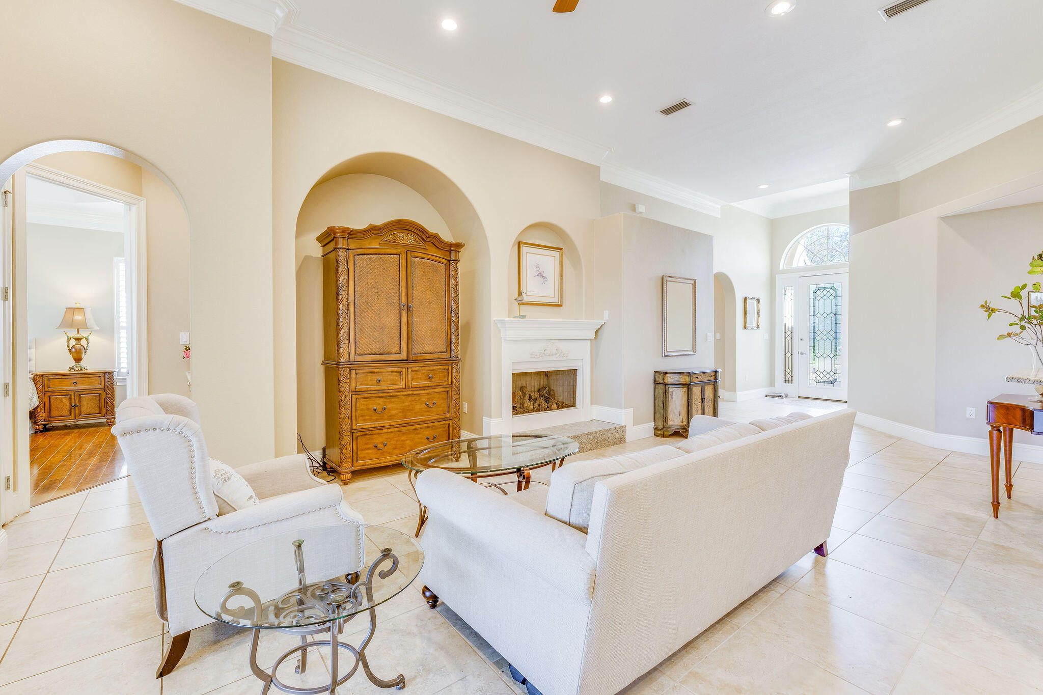 a living room with fireplace furniture and a large window