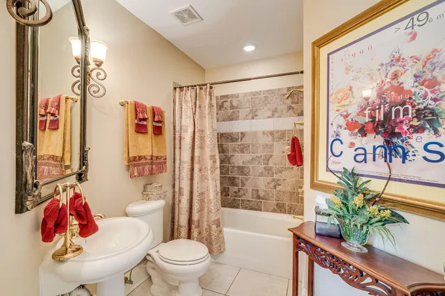 a white toilet sitting next to a bathroom sink and tub