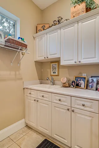 a kitchen with white cabinets and a sink
