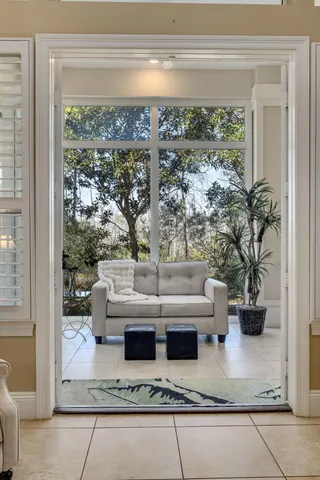 a view of living room filled with furniture and a potted plant