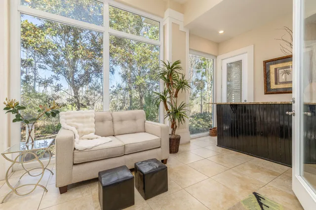 a living room with furniture and a floor to ceiling window