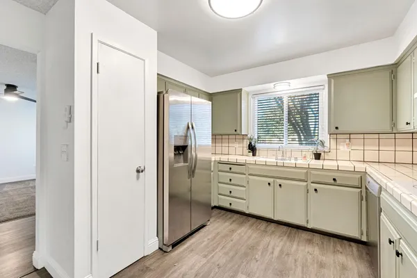 a large bathroom with a double vanity sink a mirror and a bathtub
