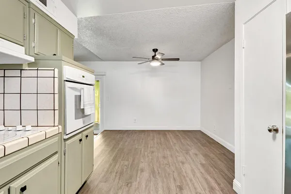 a view of a kitchen with a sink and wooden floor