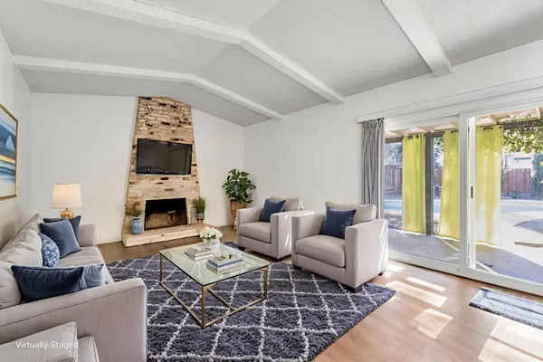 a living room with furniture a rug and a fireplace