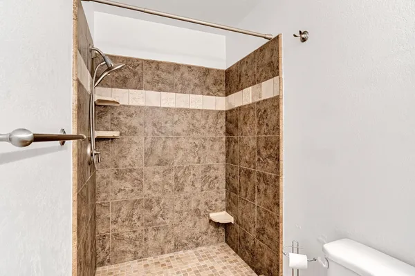 a bathroom with a shower toilet and sink