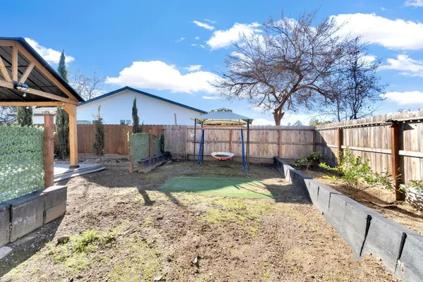 a view of a backyard with a large tree