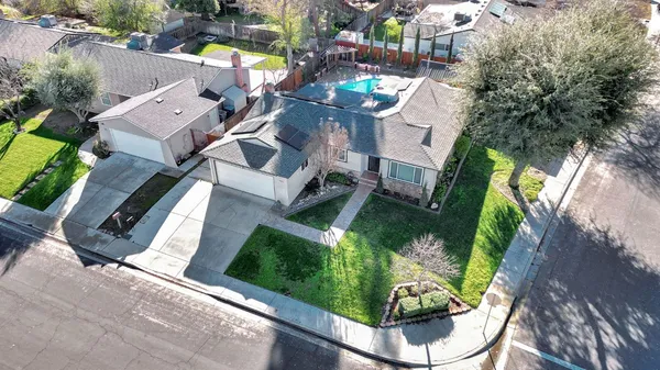 an aerial view of a house with a yard and garden