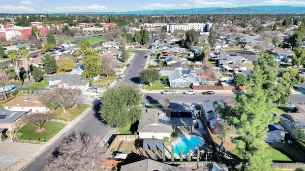 an aerial view of a house with a yard and lake view