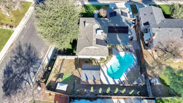 an aerial view of a house with a yard swimming pool and outdoor seating