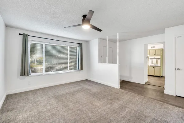 an empty room with windows and closet