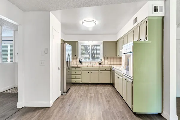 a kitchen with stainless steel appliances a sink and a refrigerator