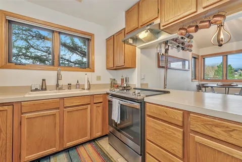 a kitchen with a sink cabinets and window