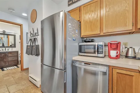 a kitchen with stainless steel appliances granite countertop a refrigerator and a sink