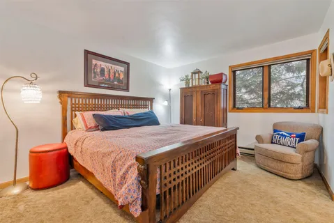 a bedroom with a bed and a painting on the wall