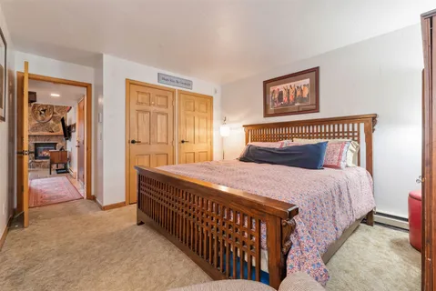 a bedroom with a bed and a mirror