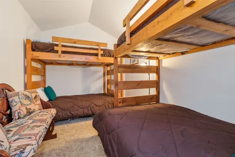 a bedroom with two beds and a window