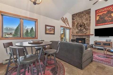 a living room with furniture a flat screen tv and a fireplace