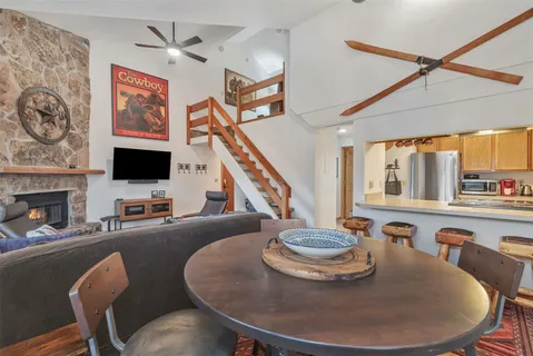 a dining room with furniture a flat screen tv and a fireplace
