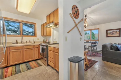 a spacious bathroom with a sink a mirror a bathtub and next to a window