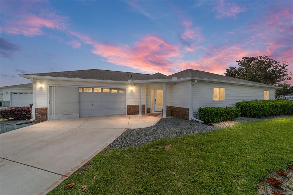 8608 Southeast 141st Street Road Summerfield, FL 34491 - Photo 1 of 82 a front view of a house with a yard and garage