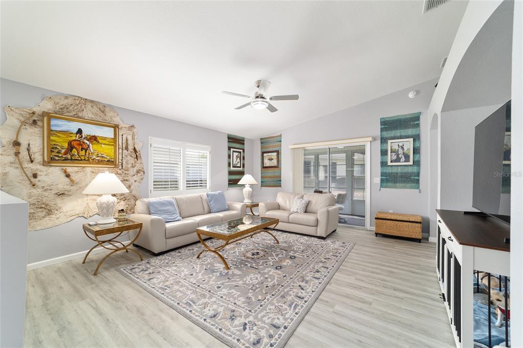 8608 Southeast 141st Street Road Summerfield, FL 34491 - Photo 12 of 82 a living room with furniture and wooden floor
