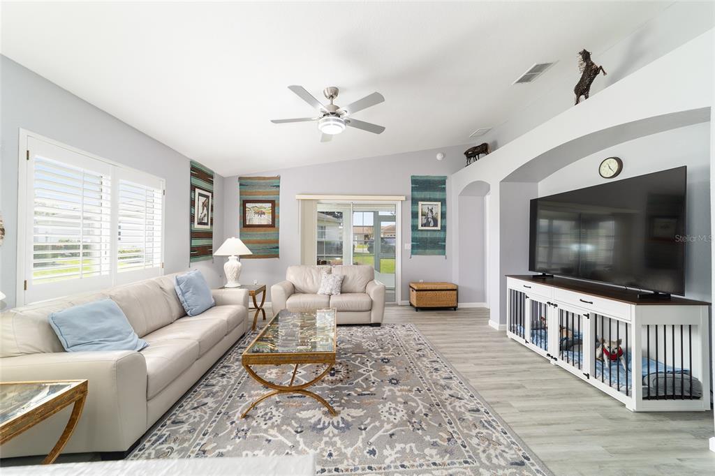 8608 Southeast 141st Street Road Summerfield, FL 34491 - Photo 13 of 82 a living room with furniture and a flat screen tv