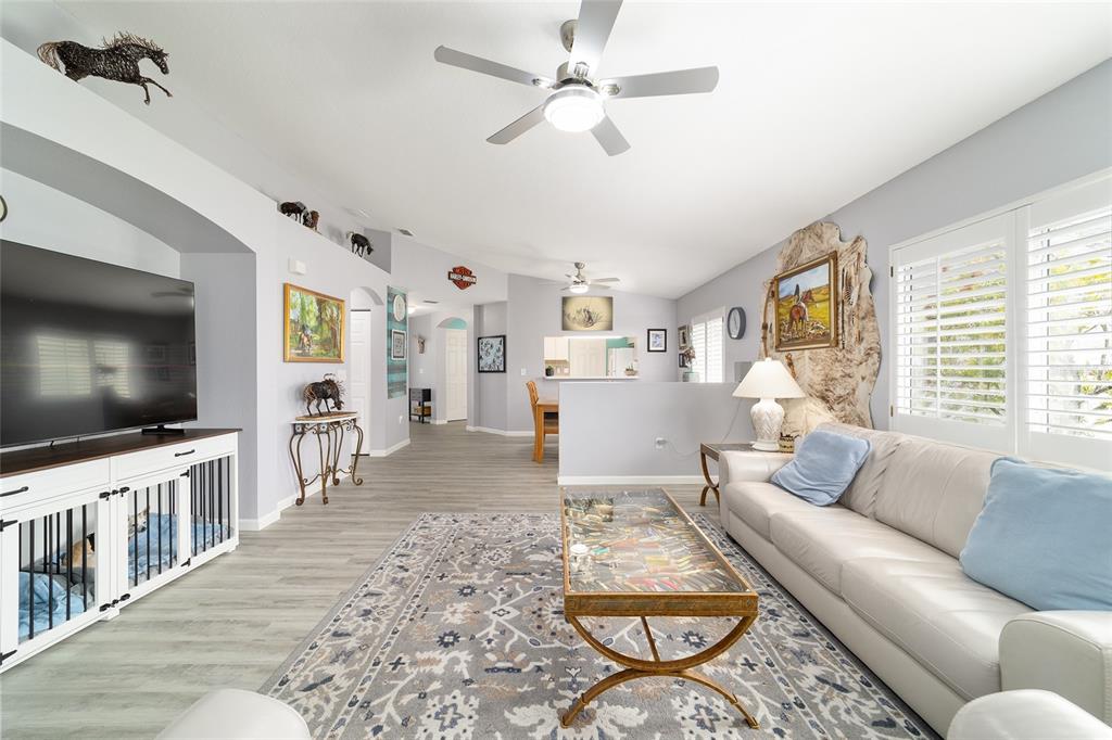 8608 Southeast 141st Street Road Summerfield, FL 34491 - Photo 17 of 82 a living room with furniture and a flat screen tv