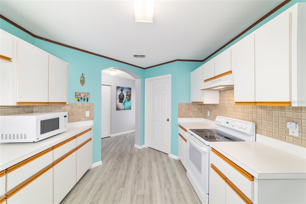 8608 Southeast 141st Street Road Summerfield, FL 34491 - Photo 22 of 82 a kitchen with stainless steel appliances granite countertop a stove and a refrigerator
