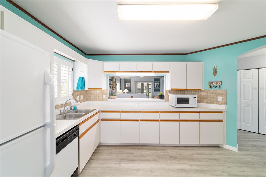 8608 Southeast 141st Street Road Summerfield, FL 34491 - Photo 23 of 82 a large white kitchen with a large window