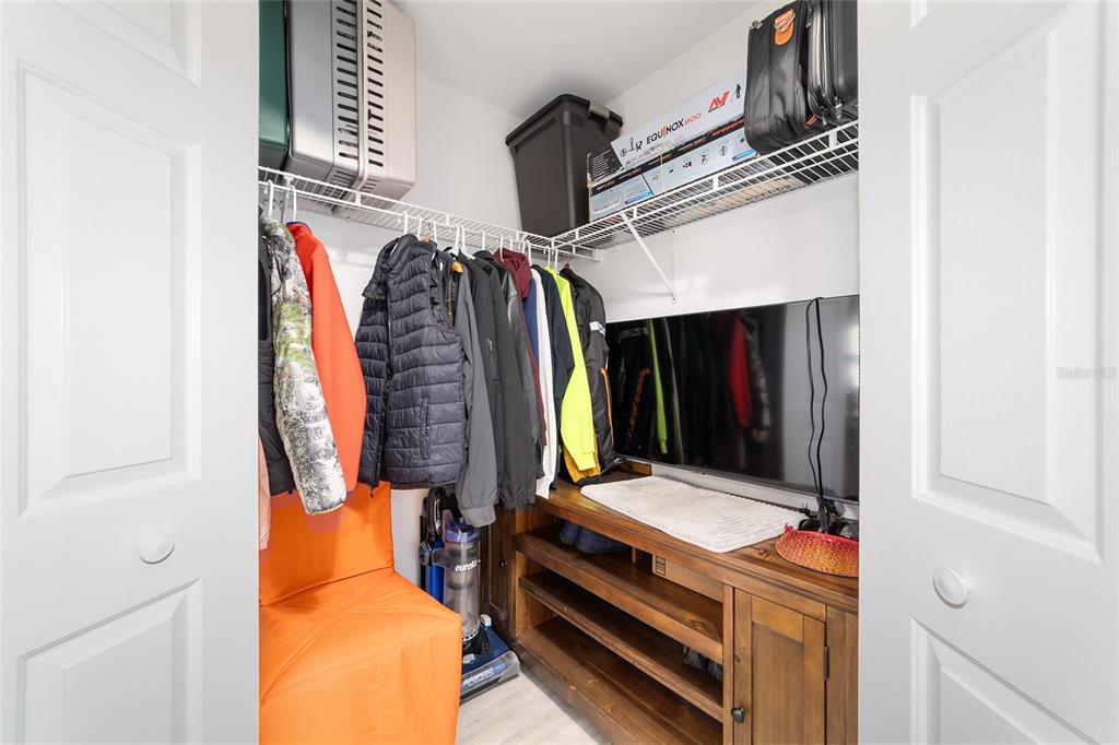 8608 Southeast 141st Street Road Summerfield, FL 34491 - Photo 28 of 82 a view of walk in closet with clothes and shoes