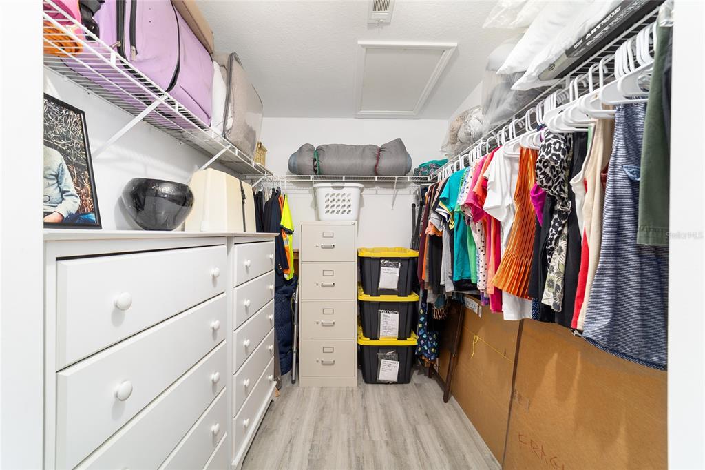 8608 Southeast 141st Street Road Summerfield, FL 34491 - Photo 29 of 82 a view of walk in closet with clothes and shoes