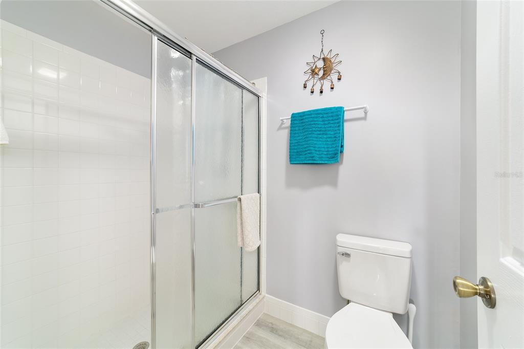 8608 Southeast 141st Street Road Summerfield, FL 34491 - Photo 32 of 82 a bathroom with a toilet and a shower