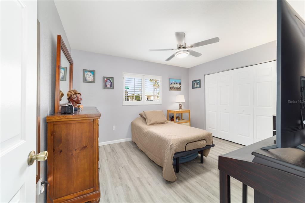 8608 Southeast 141st Street Road Summerfield, FL 34491 - Photo 33 of 82 a bedroom with a bed and wooden floor