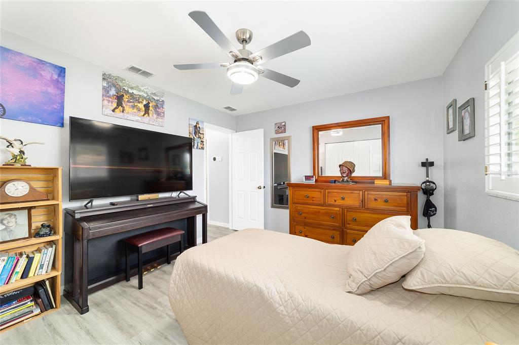 8608 Southeast 141st Street Road Summerfield, FL 34491 - Photo 34 of 82 a bedroom with a bed and a flat screen tv